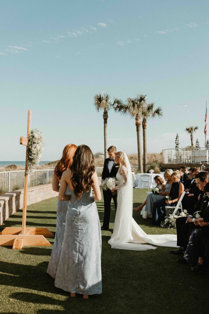 Bride and groom exchanging vows at Amelia Island Club beachfront ceremony