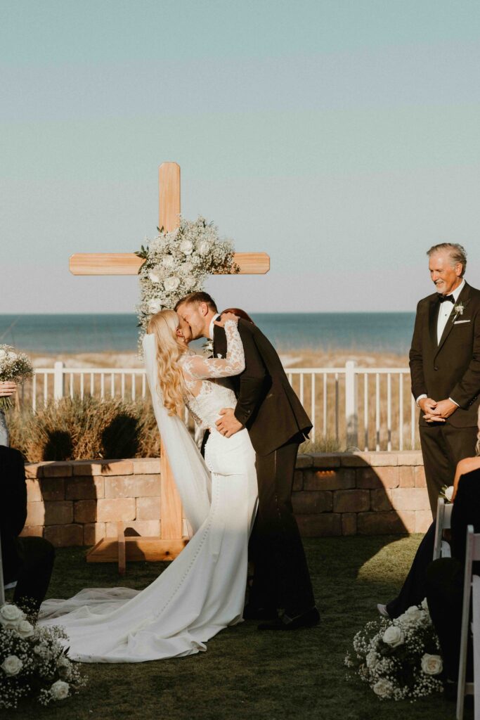 Bride and groom have their first kiss as husband and wife at Amelia Island Club beachfront ceremony